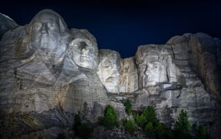 Photo of Mount Rushmore at night.