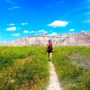 Photo of a Beautiful Woman Hiking in the Badlands, One of the Best Day Trips from Mount Rushmore.