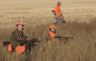 Three men hunting in South Dakota.