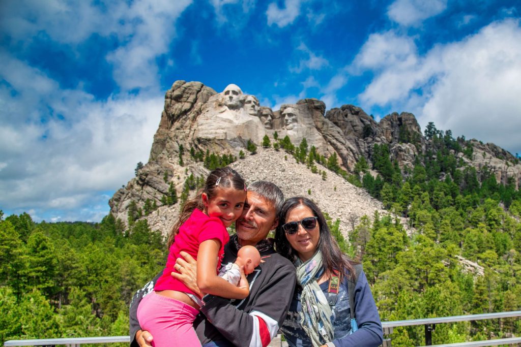 A family of three enjoying Best Time To Visit Mount Rushmore.