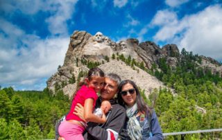 A family of three enjoying Best Time To Visit Mount Rushmore.